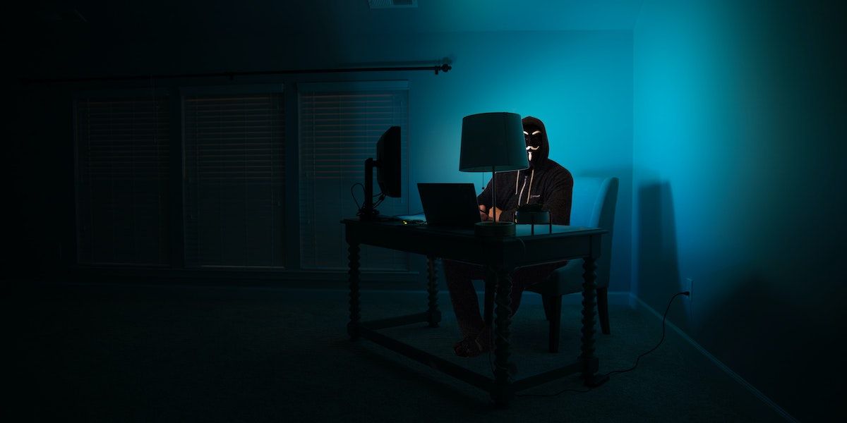 一個坐在筆記本電腦前的網絡罪犯